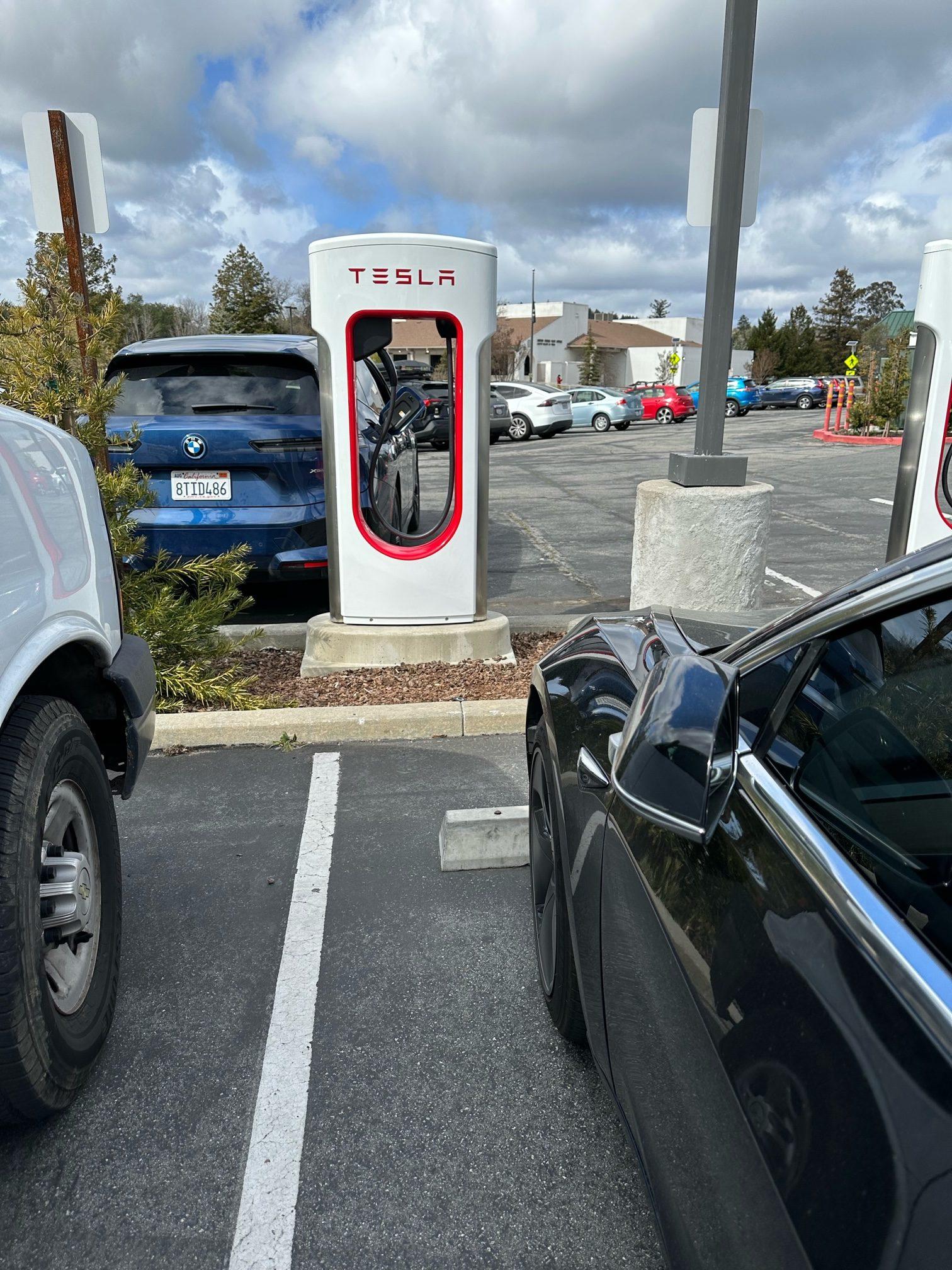 Tesla Model 2 First Supercharger with Magic Dock CCS Adapter charges up a Rivian tesla